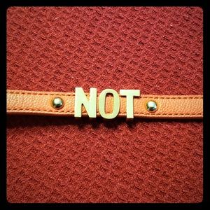 Orange leather band snap on bracelet says NOT